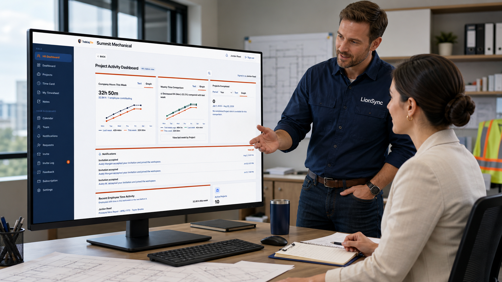 An HR professional and LionSync contractor reviewing the TradeLog Site HR Dashboard in an office.